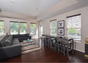 Thumbnail 13 of 32 - a living room with a couch and a dining table
