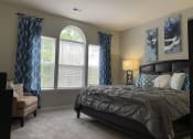 Thumbnail 29 of 32 - a bedroom with a bed and windows with curtains