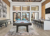 Thumbnail 20 of 38 - a pool table in a room with a bar and tables