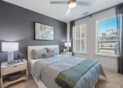 Thumbnail 6 of 38 - a bedroom with a large bed and a ceiling fan