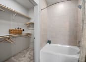 Thumbnail 14 of 38 - a bathroom with a tub and a shower and a curtain