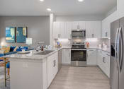 Thumbnail 4 of 38 - a kitchen with white cabinets and stainless steel appliances