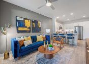 Thumbnail 9 of 38 - a living room with a couch and a table