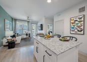 Thumbnail 3 of 38 - an open kitchen and living room with a large counter top