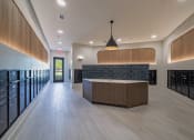 Thumbnail 15 of 35 - the tasting room has a large counter and a row of wine racks