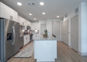 Thumbnail 4 of 35 - a kitchen with stainless steel appliances and white cabinets