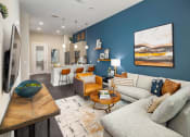 Thumbnail 14 of 41 - a living room with a couch and a table