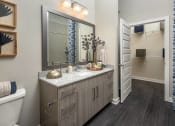 Thumbnail 19 of 41 - a bathroom with a large mirror and a sink