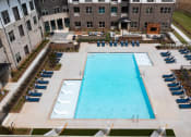 Thumbnail 36 of 41 - an aerial view of a swimming pool in front of an apartment building