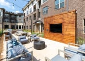 Thumbnail 21 of 41 - an outdoor patio with furniture and a tv