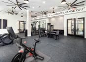 Thumbnail 27 of 41 - a home gym with exercise equipment and a sign that says weight change you