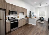 Thumbnail 2 of 41 - a kitchen with a stove and a refrigerator