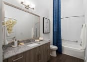 Thumbnail 18 of 41 - a bathroom with a shower and a sink and a mirror