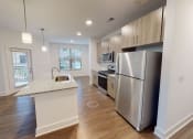 Thumbnail 7 of 41 - A kitchen with a sink and a refrigerator.