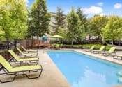 Thumbnail 5 of 44 - a swimming pool with lawn chairs around it