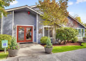 Thumbnail 6 of 44 - the front of a blue house with a red door