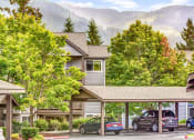 Thumbnail 7 of 44 - a view of a building with cars parked in a parking lot