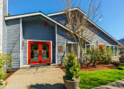 Thumbnail 13 of 44 - the front of a blue house with a red door