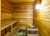 Thumbnail 19 of 44 - a large sauna with a bench and a table