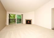Thumbnail 25 of 44 - a living room with a fireplace and a window