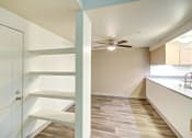 Thumbnail 28 of 44 - a kitchen with white cabinets and a ceiling fan
