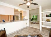 Thumbnail 29 of 44 - a kitchen and living room with a ceiling fan