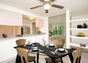 Thumbnail 30 of 44 - a dining room with a table and a ceiling fan