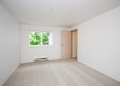 Thumbnail 31 of 44 - a white room with a window and a door