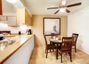 Thumbnail 32 of 44 - a dining room and kitchen with a table and chairs