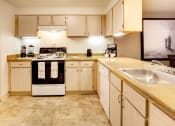 Thumbnail 33 of 44 - a large kitchen with white cabinets and a sink