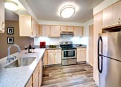Thumbnail 34 of 44 - a kitchen with stainless steel appliances and wooden cabinets
