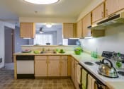 Thumbnail 35 of 44 - a kitchen with wooden cabinets and a stove and sink