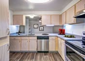 Thumbnail 39 of 44 - spacious kitchen with wood cabinets and stainless steel appliances at the preserve at great neck apartments