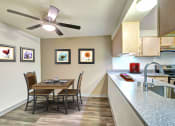 Thumbnail 40 of 44 - a dining room table with chairs next to a kitchen