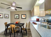 Thumbnail 41 of 44 - a dining room table with chairs next to a kitchen