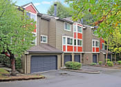 Thumbnail 16 of 28 - the view of a apartment building with a garage door