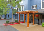 Thumbnail 22 of 28 - a wood archway in front of a blue building