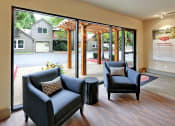 Thumbnail 25 of 28 - a living room with two chairs and a table