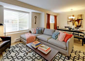 Thumbnail 1 of 28 - a living room with a couch and a coffee table