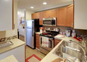 Thumbnail 6 of 28 - a kitchen with stainless steel appliances and wooden cabinets
