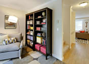 Thumbnail 8 of 28 - a living room with a couch and a bookcase