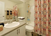 Thumbnail 13 of 28 - a bathroom with a sink toilet and shower