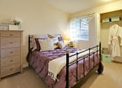 Thumbnail 12 of 28 - a bedroom with a bed and a dresser