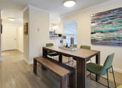Thumbnail 22 of 30 - a dining room with a table and chairs