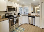 Thumbnail 24 of 30 - a kitchen with stainless steel appliances and white cabinets