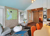Thumbnail 20 of 30 - a living room with furniture and a map on the wall