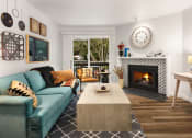 Thumbnail 7 of 27 - a living room with a blue couch and a fireplace