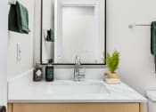 Thumbnail 23 of 27 - a bathroom with a sink and a mirror