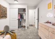Thumbnail 22 of 27 - a bedroom with a closet and a bed and a chair