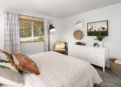 Thumbnail 21 of 27 - a bedroom with a bed and a dresser